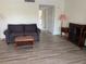 Cozy living room with wood floors, a comfortable sofa, and ample natural light, perfect for relaxing and entertaining at 7211 W Country Club N Dr # 135, Sarasota, FL 34243