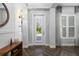 Tastefully designed foyer featuring herringbone floors, white trim, and wood accents at 833 Honeyflower Loop, Bradenton, FL 34212