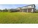 Expansive backyard featuring a well-maintained lawn and screened-in porch, perfect for outdoor living and entertaining at 8609 Evening Dr, Sarasota, FL 34241