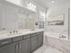 Elegant bathroom with double vanity, soaking tub, and luxurious marble finishes at 8609 Evening Dr, Sarasota, FL 34241