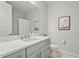 Modern bathroom features a sleek vanity with white countertop and elegant fixtures at 8609 Evening Dr, Sarasota, FL 34241