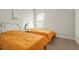 Bright bedroom features two twin beds with matching yellow blankets and decor at 8609 Evening Dr, Sarasota, FL 34241