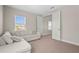 Comfortable bedroom with large sectional sofa, blinds, and neutral color palette at 8609 Evening Dr, Sarasota, FL 34241
