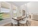 Elegant dining room with large windows, modern decor, and stylish furniture at 8609 Evening Dr, Sarasota, FL 34241