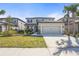 Two story modern home with a two car garage, a well maintained yard, and landscaped bushes at 8609 Evening Dr, Sarasota, FL 34241