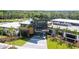 Community clubhouse with a modern architectural design, featuring a spacious entrance and lush tropical landscaping at 8609 Evening Dr, Sarasota, FL 34241