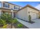 Front exterior of home with dark accents, a well maintained yard, and landscaped bushes at 8609 Evening Dr, Sarasota, FL 34241