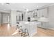 Bright, airy kitchen with white cabinets, stainless steel appliances, and a large center island at 8609 Evening Dr, Sarasota, FL 34241