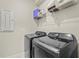 Laundry room with modern washer and dryer, and wire shelving for storage at 8609 Evening Dr, Sarasota, FL 34241