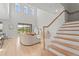 Bright living room with modern furniture, hardwood flooring, and staircase with backyard view at 8609 Evening Dr, Sarasota, FL 34241