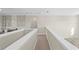 Loft featuring neutral walls, carpet, and a view of a desk in the background at 8609 Evening Dr, Sarasota, FL 34241