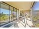 Covered patio with dining table, grill, and view of the backyard and nearby lake at 8609 Evening Dr, Sarasota, FL 34241