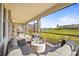 Relaxing screened patio featuring comfortable seating and tranquil lake views at 8609 Evening Dr, Sarasota, FL 34241