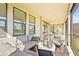 Relaxing screened patio with comfortable seating and outdoor kitchen in the background at 8609 Evening Dr, Sarasota, FL 34241