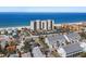 Expansive aerial view of beachfront property featuring modern architecture, sandy beach, and clear ocean waters at 900 Gulf Blvd # 805, Indian Rocks Beach, FL 33785