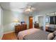 Bedroom featuring a mirrored closet, wood floors, and a ceiling fan at 900 Gulf Blvd # 805, Indian Rocks Beach, FL 33785