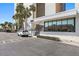 Building entrance featuring a modern facade, glass windows, prominent signage, and convenient parking at 900 Gulf Blvd # 805, Indian Rocks Beach, FL 33785