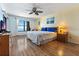 Spacious bedroom features a ceiling fan, wood floors, and a large window overlooking the ocean at 900 Gulf Blvd # 805, Indian Rocks Beach, FL 33785