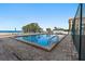 Community pool with beach view, lounge chairs, and ocean access at 900 Gulf Blvd # 805, Indian Rocks Beach, FL 33785