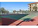 Community tennis courts at beachfront condo with building in background at 900 Gulf Blvd # 805, Indian Rocks Beach, FL 33785