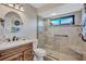 Beautiful bathroom features a tiled walk-in shower with a seat and a vanity with solid surface countertop at 104 Inlets Blvd # 104, Nokomis, FL 34275