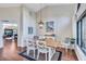 Bright dining room with hardwood floors, comfortable seating, and natural light from large window at 104 Inlets Blvd # 104, Nokomis, FL 34275