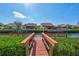 Red wood dock provides direct access to a canal surrounded by lush landscaping at 104 Inlets Blvd # 104, Nokomis, FL 34275