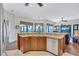 Open kitchen area featuring granite countertops, wood cabinets, stainless appliances, and island sink at 104 Inlets Blvd # 104, Nokomis, FL 34275