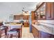 Modern kitchen with granite countertops, wood cabinets, stainless appliances, and ample storage at 104 Inlets Blvd # 104, Nokomis, FL 34275