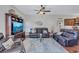 Inviting living room featuring leather sofas, a decorative fish sculpture, and a modern TV console at 104 Inlets Blvd # 104, Nokomis, FL 34275