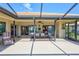 Covered patio with outdoor dining set, ideal for relaxation and entertaining near sliding doors at 104 Inlets Blvd # 104, Nokomis, FL 34275
