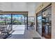 Screened lanai with outdoor seating offering picturesque views of the water and nearby homes at 104 Inlets Blvd # 104, Nokomis, FL 34275
