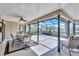 Spacious screened lanai perfect for outdoor dining and entertaining with a ceiling fan at 104 Inlets Blvd # 104, Nokomis, FL 34275