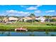 Waterfront homes with backyard views of canal, private docks and green lawn at 104 Inlets Blvd # 104, Nokomis, FL 34275