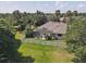 Aerial view showcasing the home's screened-in pool, lush landscaping, and fenced yard at 13811 Nighthawk Ter, Lakewood Ranch, FL 34202
