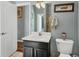 Bathroom featuring a sink, toilet, and adjacent shower area at 13811 Nighthawk Ter, Lakewood Ranch, FL 34202