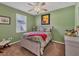 Cozy bedroom with a queen-sized bed, ceiling fan, and natural light at 13811 Nighthawk Ter, Lakewood Ranch, FL 34202
