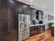 Gourmet kitchen featuring stainless steel appliances, dark cabinets, and wine storage at 13811 Nighthawk Ter, Lakewood Ranch, FL 34202