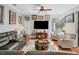 Spacious living room with hardwood floors, comfortable seating, and a large TV for entertainment at 13811 Nighthawk Ter, Lakewood Ranch, FL 34202