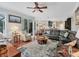 Spacious living room with hardwood floors, comfortable seating, and an open floor plan leading to the kitchen at 13811 Nighthawk Ter, Lakewood Ranch, FL 34202