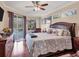 Relaxing main bedroom features a large bed, pool access, and tasteful decor at 13811 Nighthawk Ter, Lakewood Ranch, FL 34202