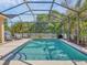 Outdoor pool within a screened enclosure, featuring clear blue water and lounge chairs at 13811 Nighthawk Ter, Lakewood Ranch, FL 34202