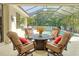 Outdoor pool area with comfortable seating under a screened enclosure and lush landscaping at 13811 Nighthawk Ter, Lakewood Ranch, FL 34202