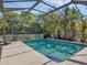 Beautiful screened-in pool with lush landscaping offering a private and relaxing backyard oasis at 13811 Nighthawk Ter, Lakewood Ranch, FL 34202