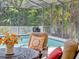 Relaxing outdoor seating by the pool within a screened enclosure at 13811 Nighthawk Ter, Lakewood Ranch, FL 34202