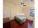 Bedroom with ceiling fan, window, and dark wood floor, offering a calm and comfortable space at 15207 17Th E Ave, Bradenton, FL 34212