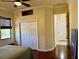 Sunny bedroom with wood floor features a ceiling fan and closet, offering a cozy retreat at 15207 17Th E Ave, Bradenton, FL 34212