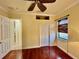 Bright, sunny bedroom with a hardwood floor and a doorway leading to the bathroom at 15207 17Th E Ave, Bradenton, FL 34212