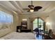 Serene bedroom with tray ceilings, a ceiling fan, and sliding doors to a screened lanai at 15207 17Th E Ave, Bradenton, FL 34212