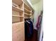 Walk-in closet features custom shelving, drawers, and ample space for organized storage and clothing at 15207 17Th E Ave, Bradenton, FL 34212